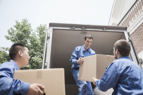 Man and van team loading recyclable household items in Streatham